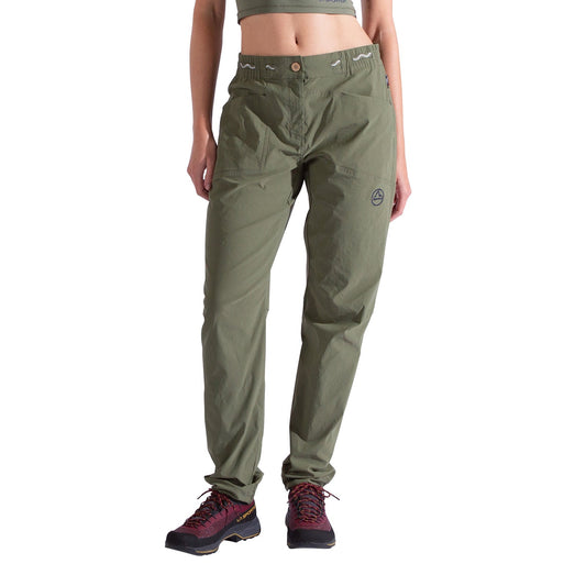 A person wears La Sportiva Mantra Pants Women's in olive green, featuring articulated knees, a logo on the left thigh, and a relaxed fit, along with black-and-red hiking shoes. They stand against a white background with the upper body partially visible.