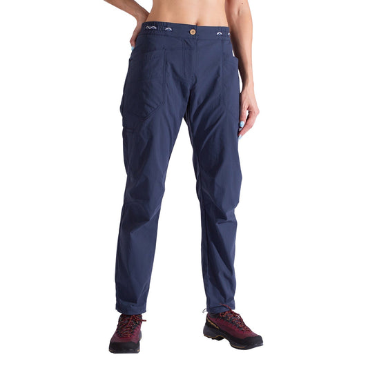 A person is shown from torso to legs wearing La Sportiva Labyrinth Pants Women's in navy, featuring durable fabric and visible front pockets, paired with burgundy hiking shoes against a white background.