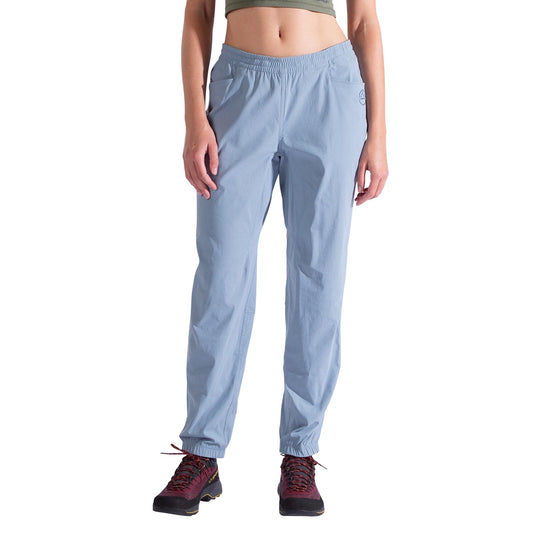 A person wearing La Sportiva Gambit Pants Women's in light blue stands facing forward against a white background, with only the lower torso and legs visible.