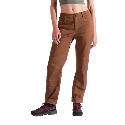 A person wears La Sportiva Mainliner Pants Women's, a green cropped top, and black hiking shoes with red laces, standing against a white background. The image displays the person from shoulders to feet.