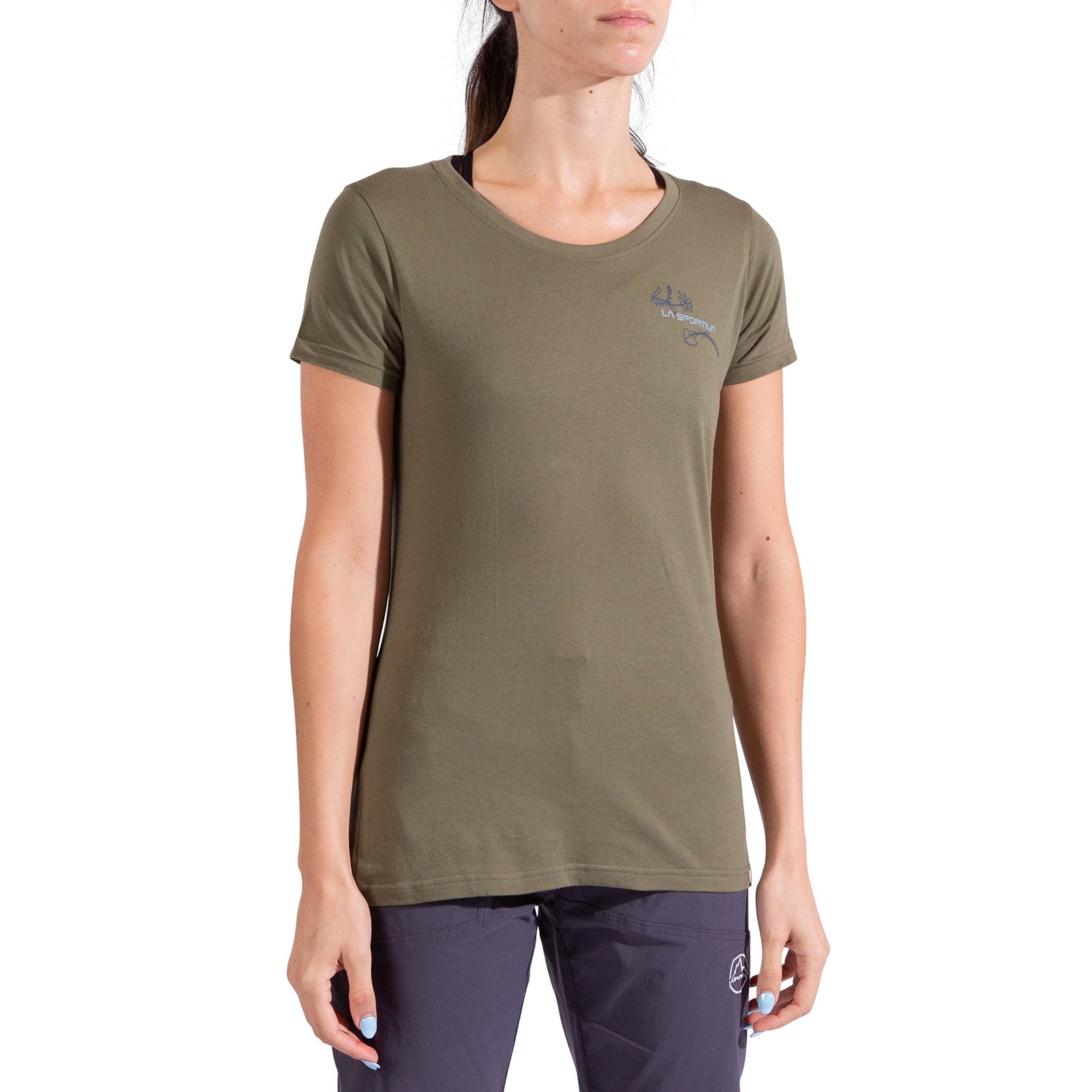 A woman wears a La Sportiva Climb Flower T-Shirt Women's in olive green, crafted from organic cotton, and dark pants. The tee has a small left-chest logo. She stands facing forward against a plain white background with her face partially out of frame.