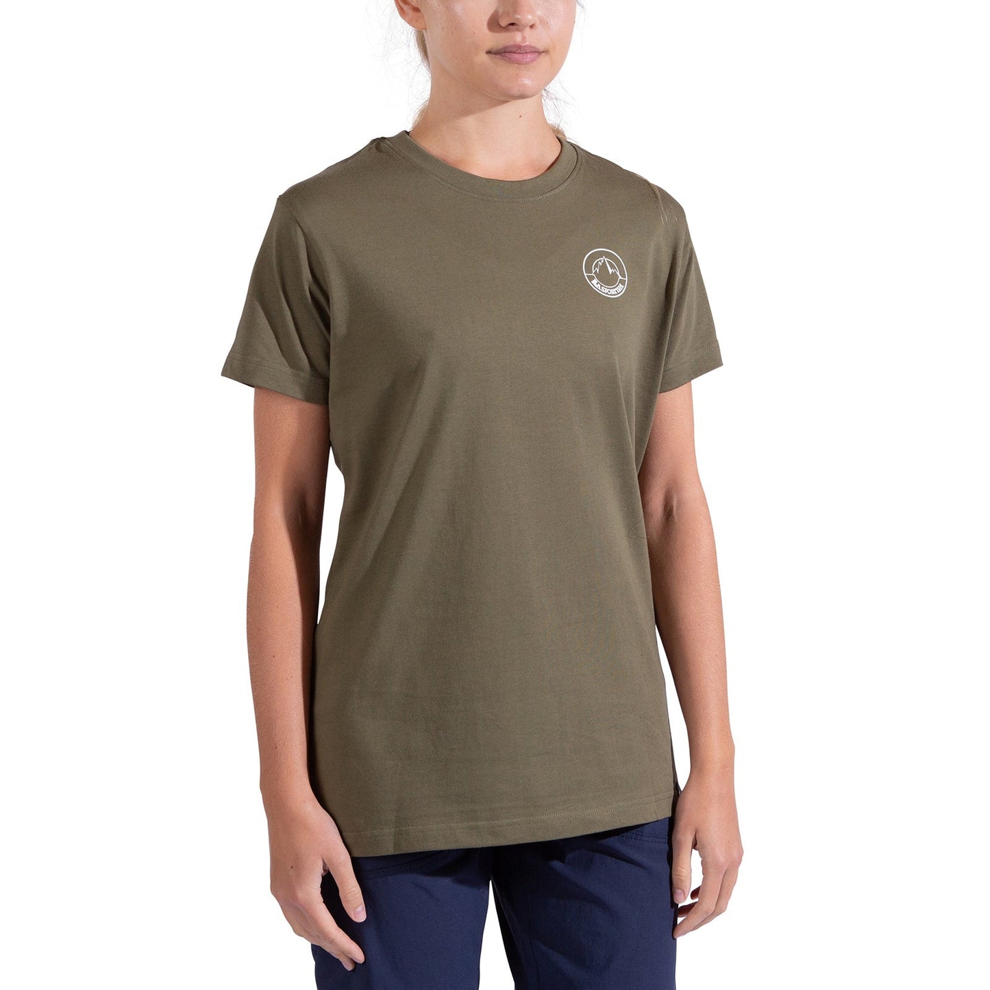 A minimalist climber wears the La Sportiva Circle Logo T-Shirt Women's in olive green, featuring a small white circular logo on the left chest, paired with navy blue pants, standing against a plain white background.