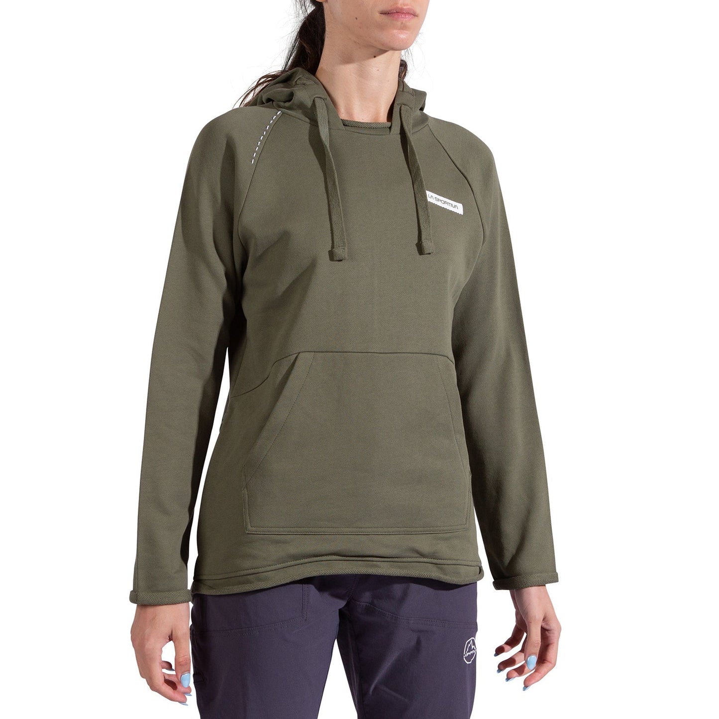 A woman wears the La Sportiva Telendos Hoody Women's in olive green—an organic cotton hoody with a front pocket and drawstrings—paired with dark pants, standing against a plain white background.