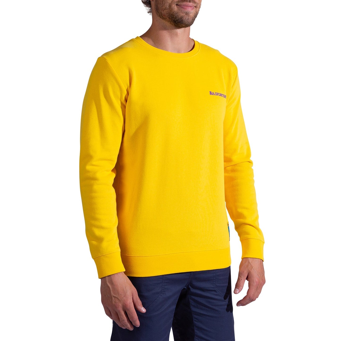 A man wearing the La Sportiva Climbing on the Moon Sweatshirt Men's in bright yellow with dark blue pants stands against a plain white background.