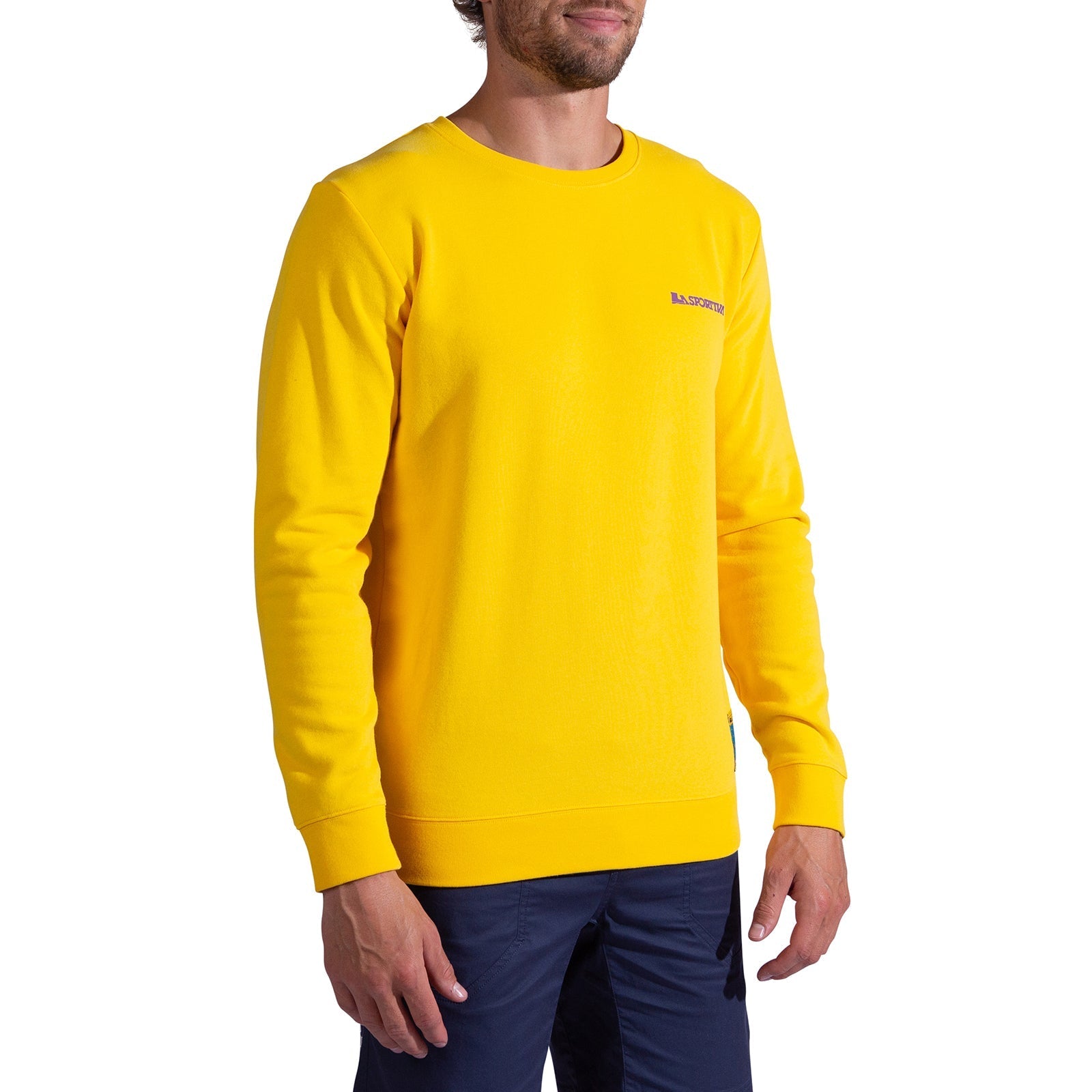 A man wearing the La Sportiva Climbing on the Moon Sweatshirt Men's in bright yellow with dark blue pants stands against a plain white background.