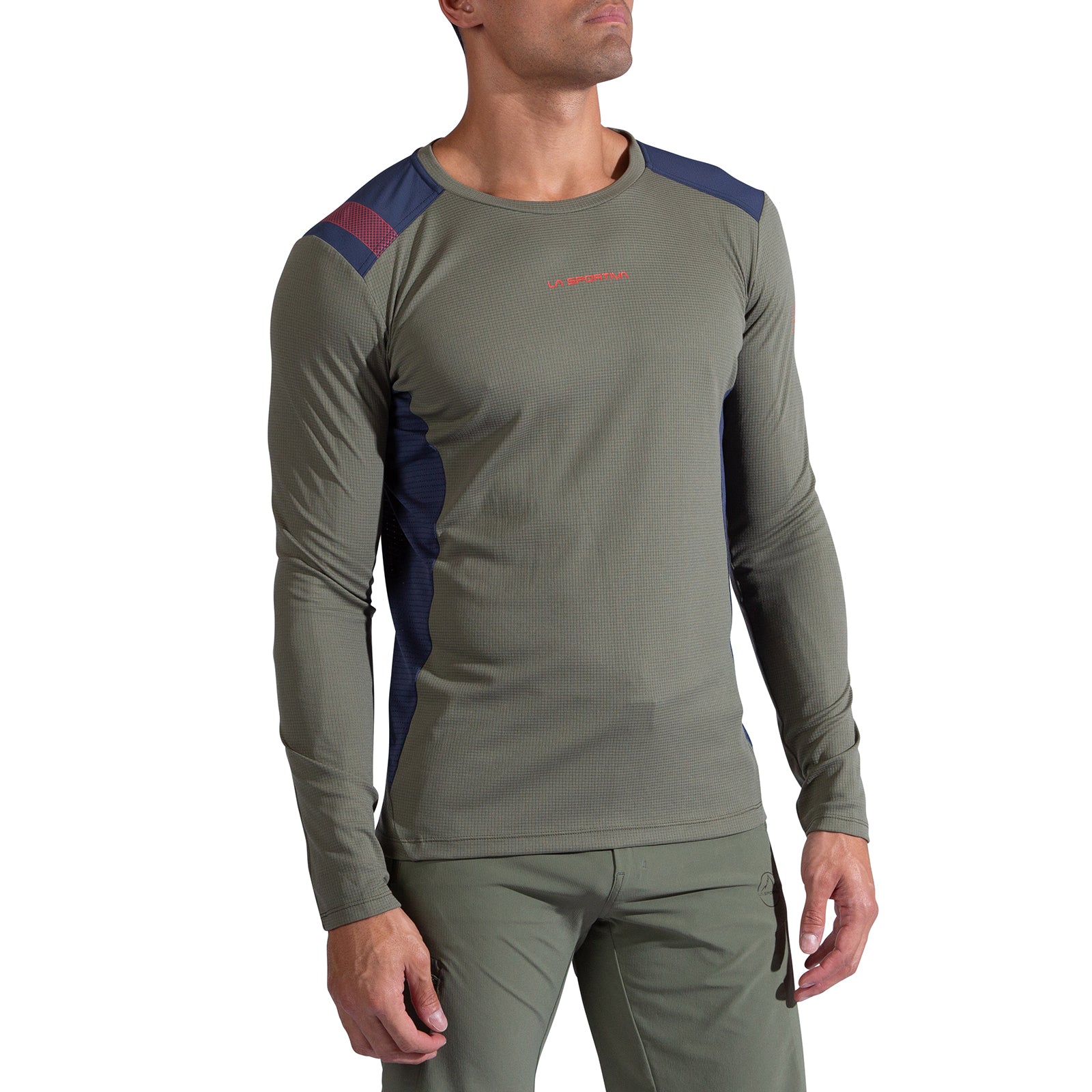 A man wearing the La Sportiva Beyond Long Sleeve Men's top in olive green with navy and maroon accents, paired with matching olive green Polartec Delta pants, stands against a white background.