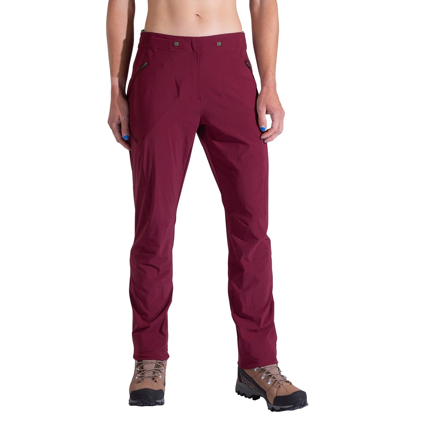 A person wears La Sportiva Monument Pants Women's in maroon with brown hiking boots, standing with arms relaxed at their sides, shown from shoulders down against a plain white background.