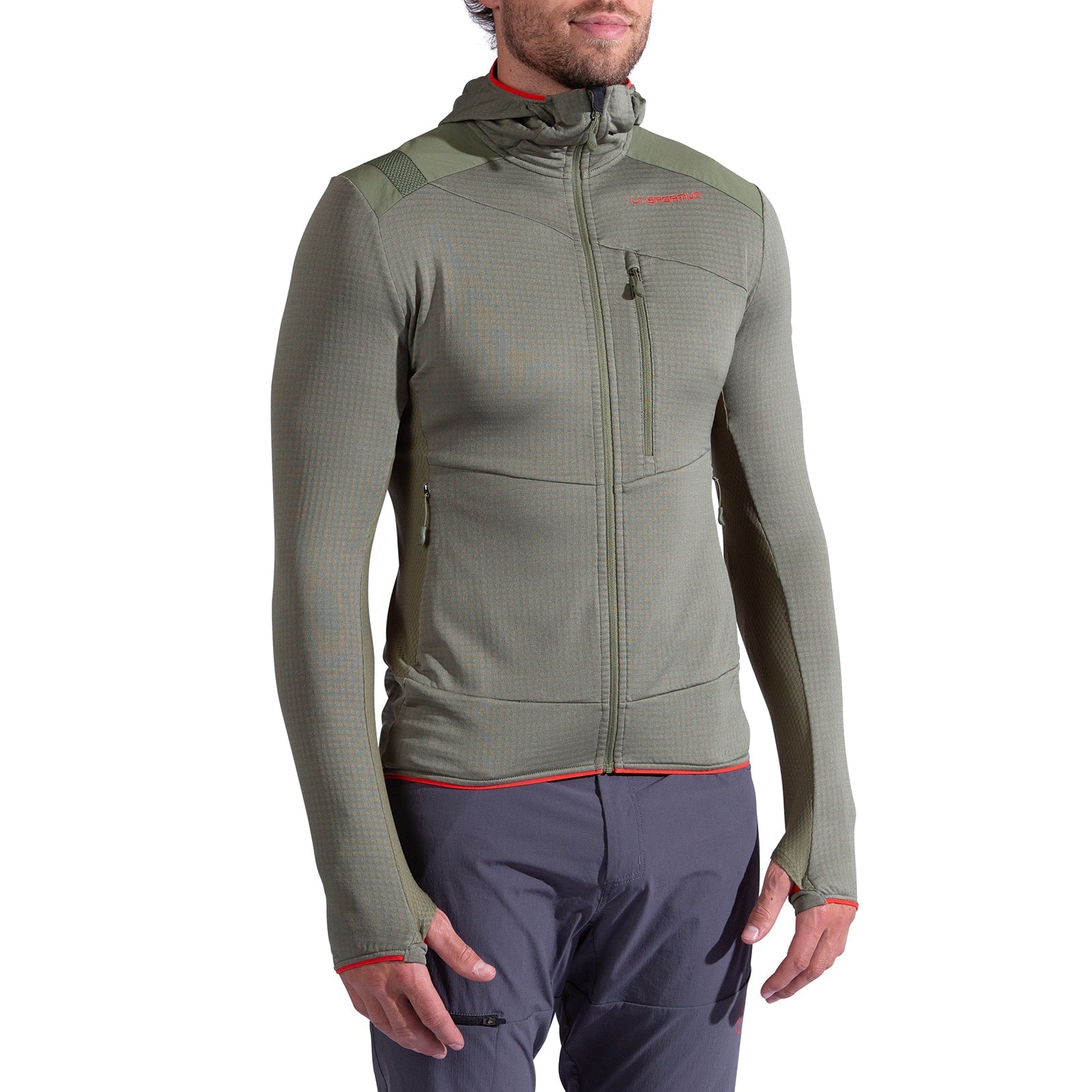 A person wears the La Sportiva Aequilibrium Thermal Hoody Men's in olive green—fitted with a front zipper, chest and side pockets, thumb holes, and red accents—perfect as a mountaineering midlayer. Paired with gray pants; head partially visible.