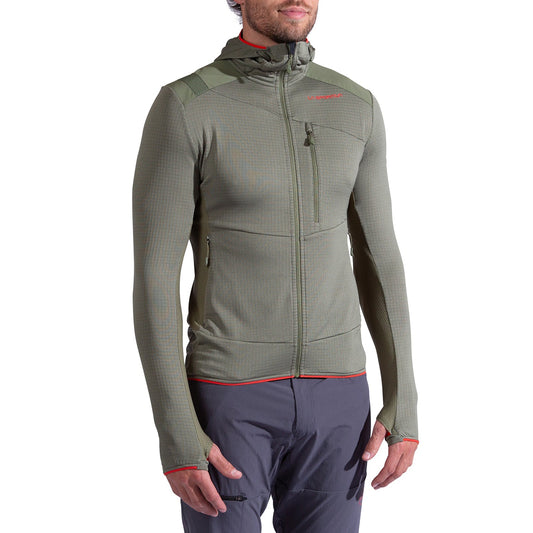 A person wears the La Sportiva Aequilibrium Thermal Hoody Men's in olive green—fitted with a front zipper, chest and side pockets, thumb holes, and red accents—perfect as a mountaineering midlayer. Paired with gray pants; head partially visible.