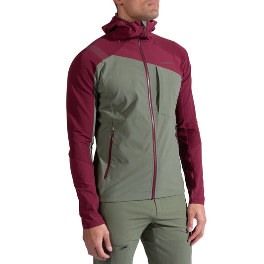 A person wearing the La Sportiva Aequilibrium Speed Jacket Men's in olive green and maroon, with a front zipper, chest pocket, and hood, stands against a plain white background.