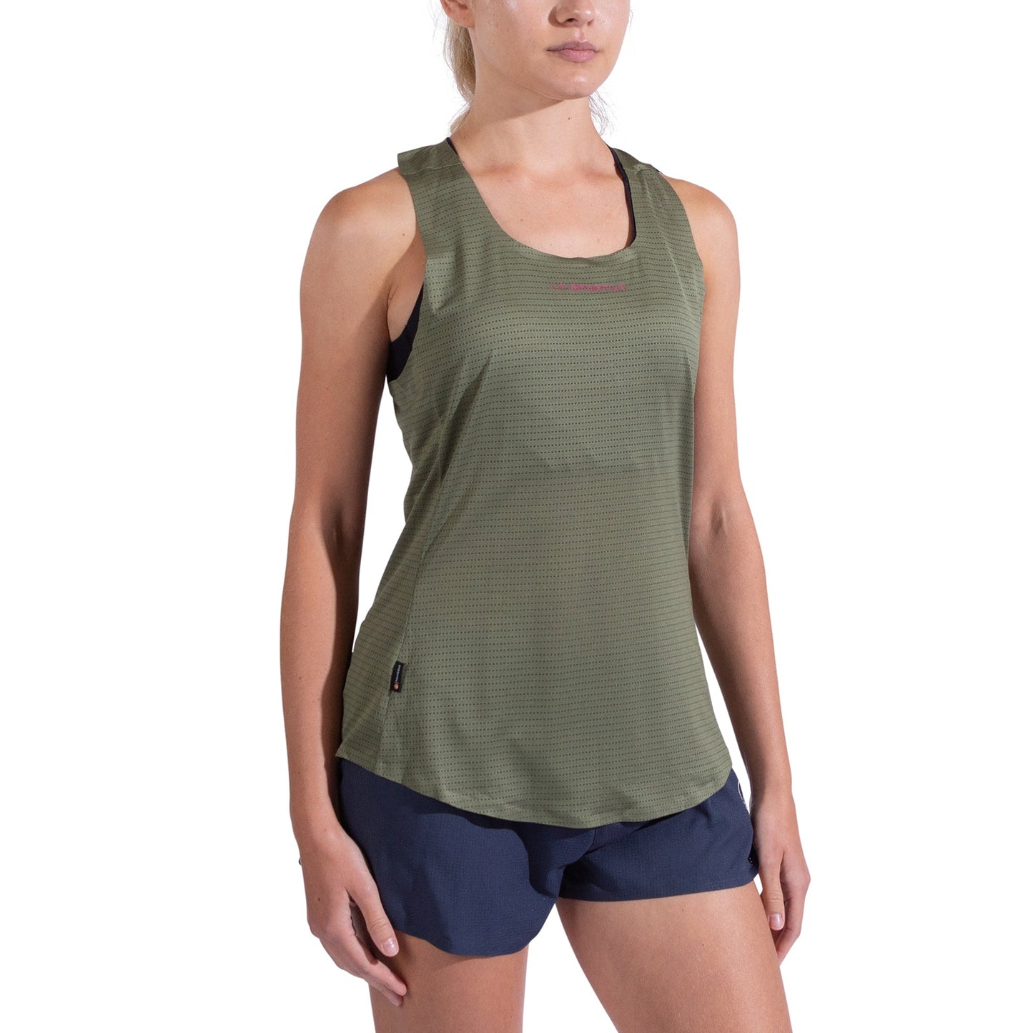 A woman stands with her arms relaxed at her sides wearing the La Sportiva Pure Tank Women's in olive green and navy blue shorts, set against a plain white background.