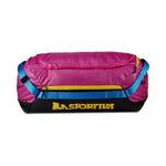 The La Sportiva Nomad 40 Duffel Bag features a pink body, yellow zippers, blue straps, and a yellow La Sportiva logo on a black base. The closed bag is shown against a white background.