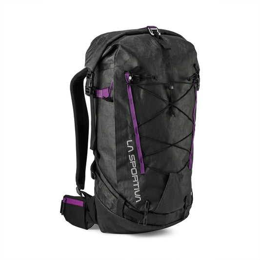 The La Sportiva Challenger 28 Backpack is black with purple accents, front bungee cords, adjustable shoulder straps, a padded hip belt, and "La Sportiva" printed vertically on the front left side.
