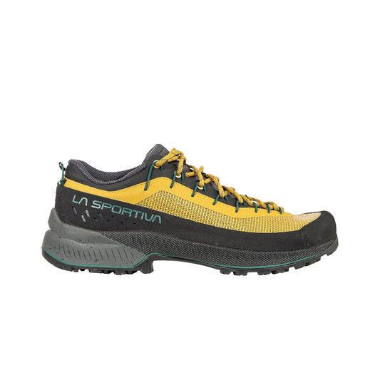 A La Sportiva TX4 EVO ST hiking shoe in yellow and black with green accents, featuring a durable tread, mesh upper, resole platform, and yellow laces, shown from the side on a white background.