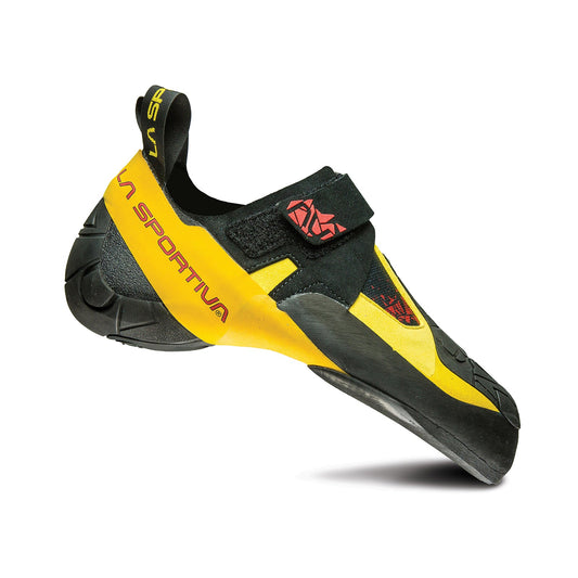 The La Sportiva Skwama is a yellow and black performance climbing shoe with a hook-and-loop closure, pointed toe, and rubber sole, designed for rock climbing. The shoe appears against a white background.