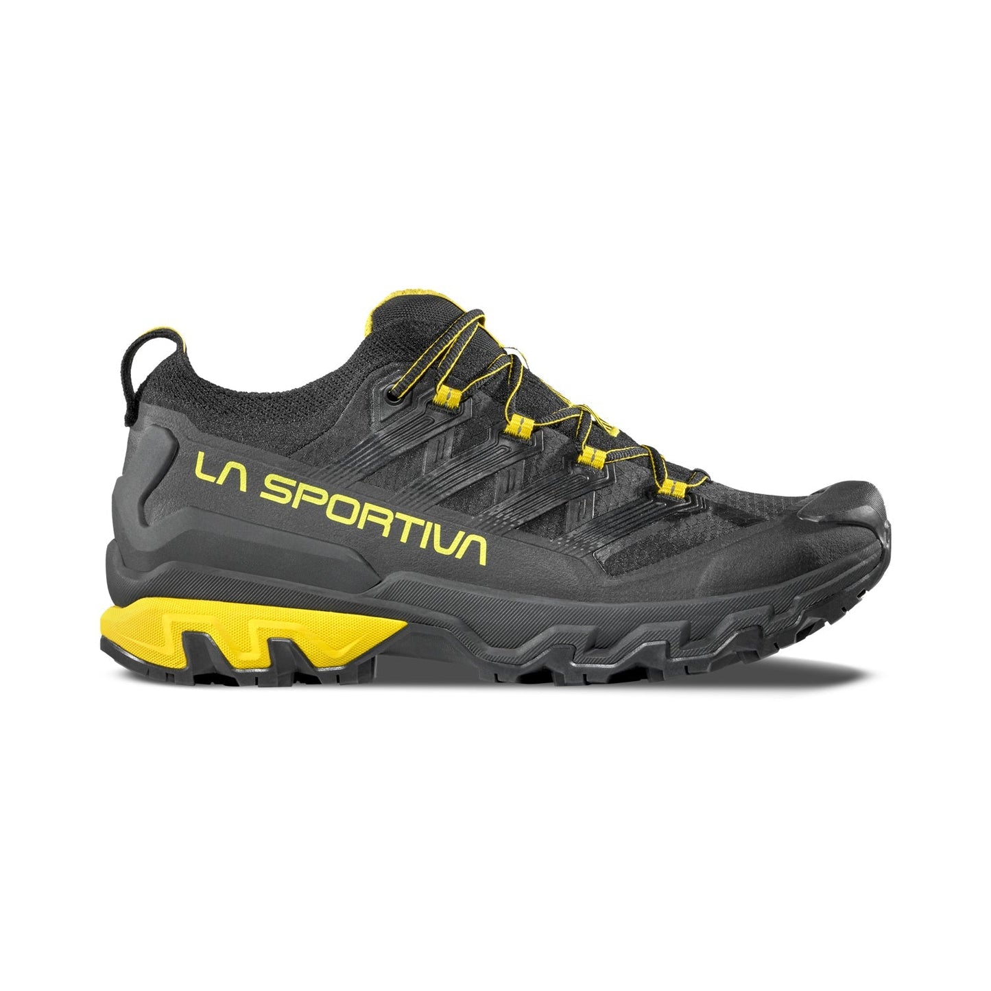 A side view of the La Sportiva Ultra Raptor 3 displays rugged soles and yellow accents, with the brand name in yellow on this breathable black and yellow trail running shoe.