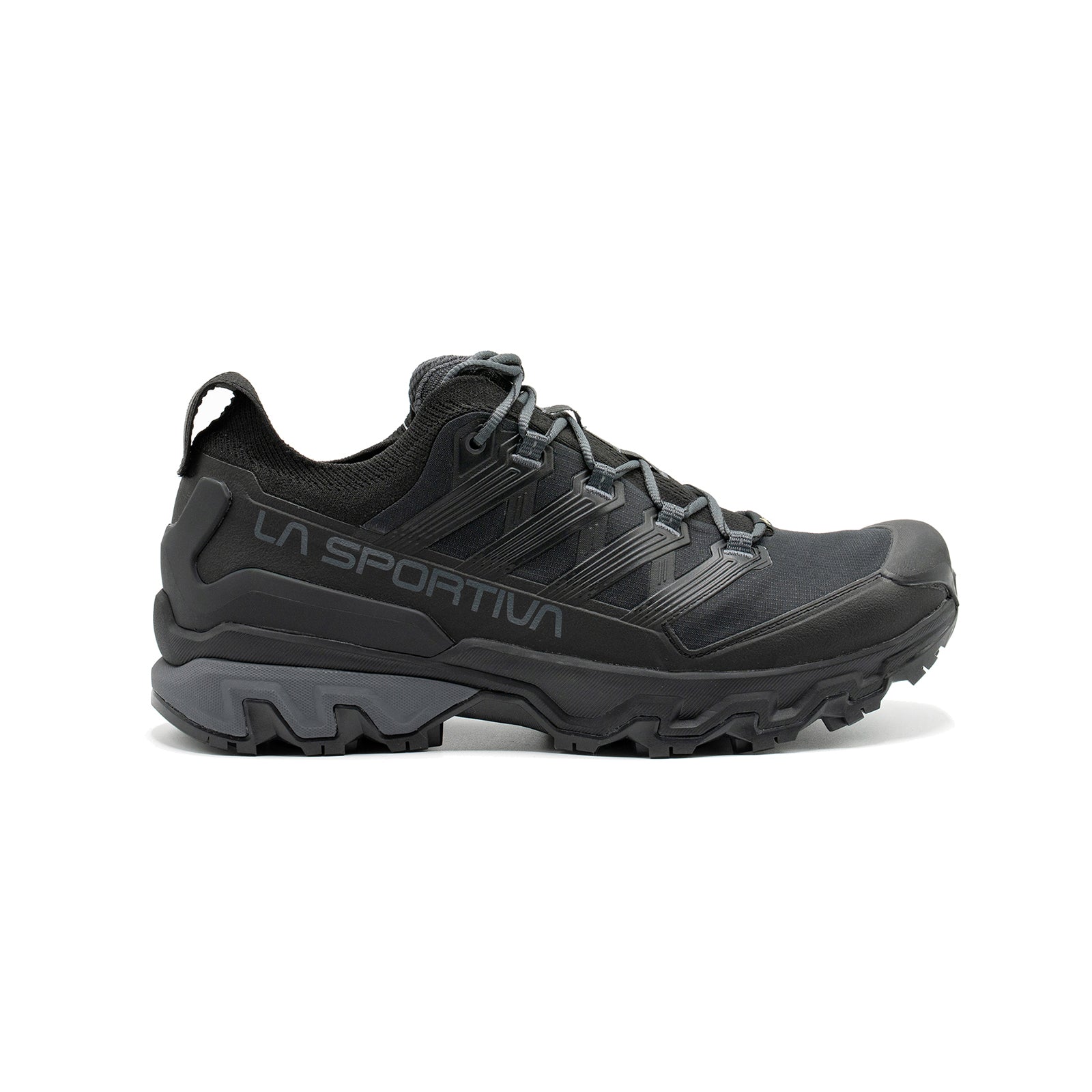 The La Sportiva Ultra Raptor 3 GTX is a black waterproof hiking shoe featuring rugged tread, mesh upper, reinforced toe, and lace-up closure, designed for trail-running agility on outdoor adventures and rough terrain.