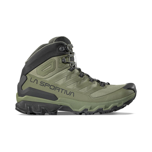 The La Sportiva Ultra Raptor 3 Mid GTX hiking boot features a green and black design, high ankle support, rugged sole, side branding, and waterproof protection; shown on a white background.