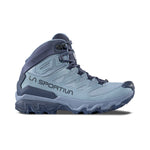 The La Sportiva Ultra Raptor 3 Mid GTX Women's waterproof hiking boot features light blue and navy colors, black laces, and rugged tread, shown from the side on a white background.
