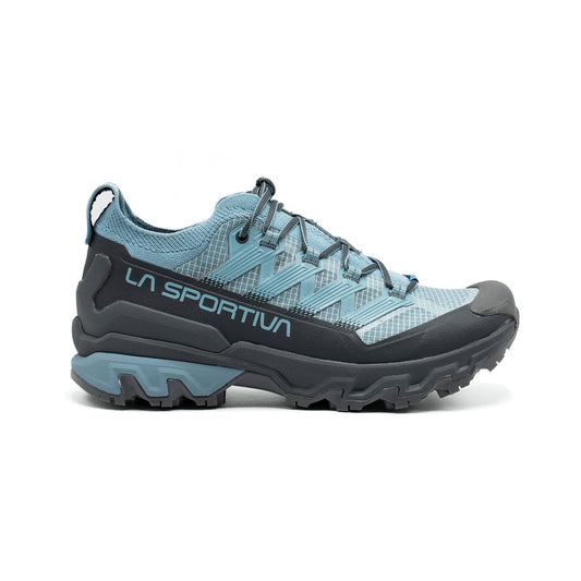 La Sportiva Ultra Raptor 3 Women's trail shoe in light blue and gray features a breathable mesh upper, rugged sole, and side branding—perfect for outdoor activities.