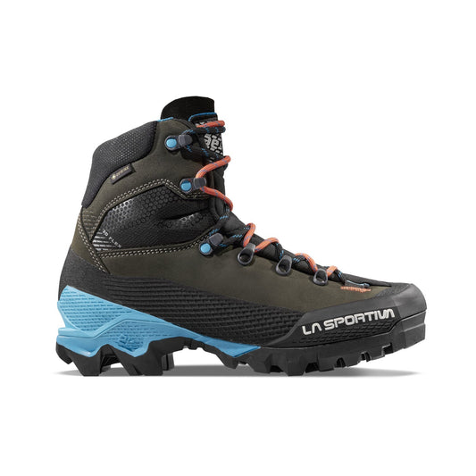 The La Sportiva Aequilibrium LT GTX Women's boot features dark green and black colors, blue accents, red lace loops, a rugged sole, ankle support, a reinforced toe, and white La Sportiva branding on the side for elite performance.