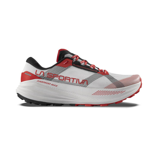 The La Sportiva Prodigio Max is a white and red trail shoe with black accents, mesh upper, and a thick Super Critical cushioned sole. LA SPORTIVA and PRODIGIO MAX are visible on the side in a side profile view.