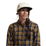 A person with long dark hair in a side braid wears the La Sportiva Guidance Beanie, standing against a plain white background.