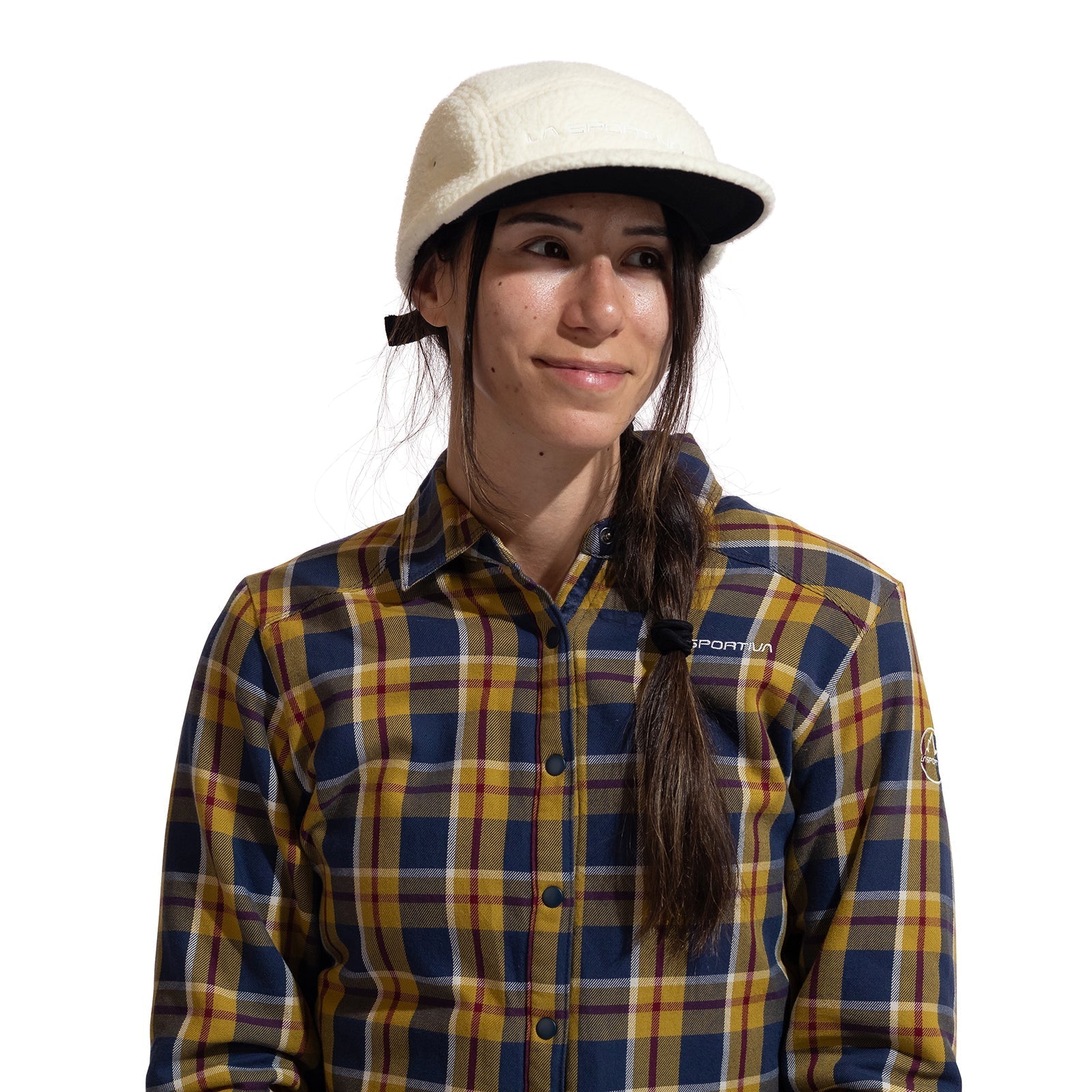 A person with long dark hair in a side braid wears the La Sportiva Guidance Beanie, standing against a plain white background.