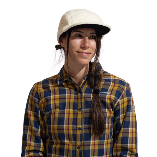 A person with long dark hair in a side braid wears the La Sportiva Guidance Beanie, standing against a plain white background.