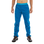 A person wearing La Sportiva Roots Pants Men's (2024) in bright blue and hiking boots stands facing forward against a white background, with only their lower body visible.