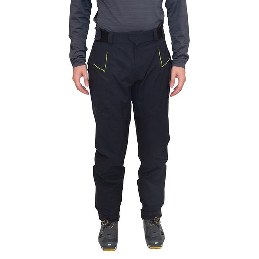 A person wearing La Sportiva Crizzle EVO Shell Pants Men’s, featuring black hardshell fabric with yellow accents, a long-sleeve dark shirt, and cycling shoes—standing facing forward against a white background.
