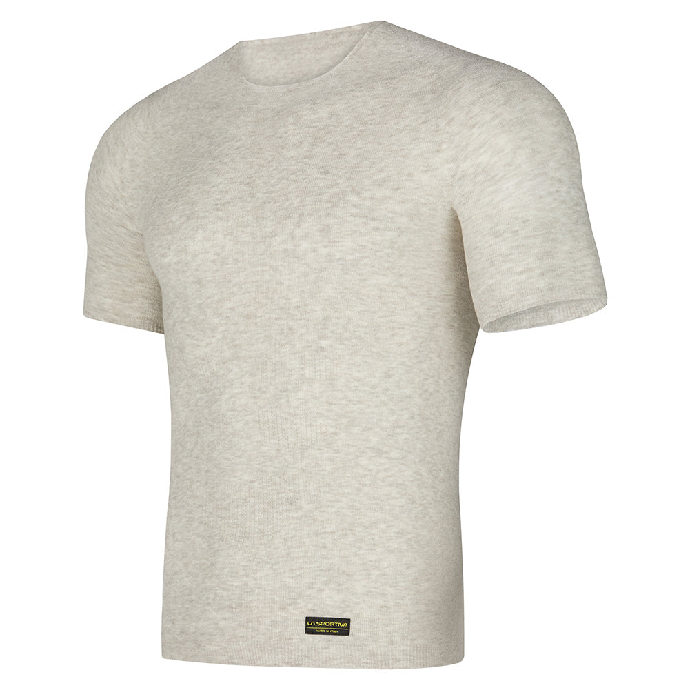 The La Sportiva Silk Reflect T-Shirt is a light beige short-sleeve tee with a round neckline, seamless Native Technology for comfort, and a small black and gold label by the bottom hem, shown on a white background.