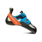 The La Sportiva Otaki rock shoe features a blue upper with orange and black details, technical edging, dual supportive straps, and a yellow pull tab, shown on a white background.